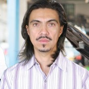 Henry Butler Man with long dark hair and dark facial hair